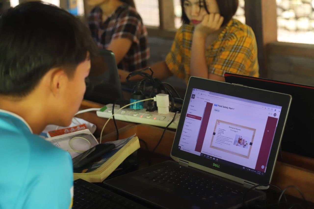 A student studying with an eduLamp Box